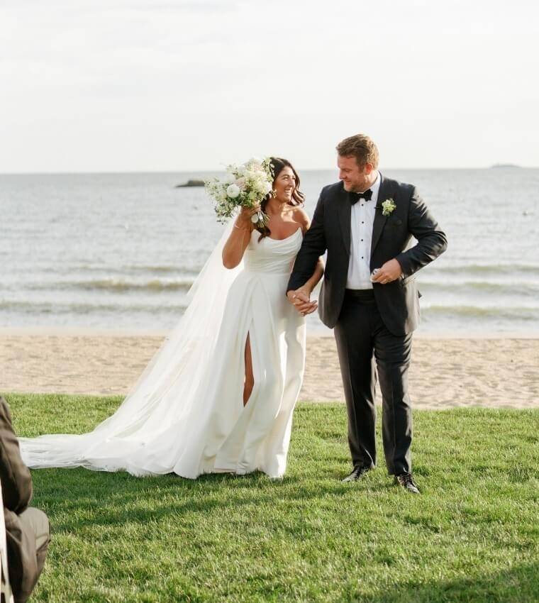 Сouple wearing a white gown and a black suit