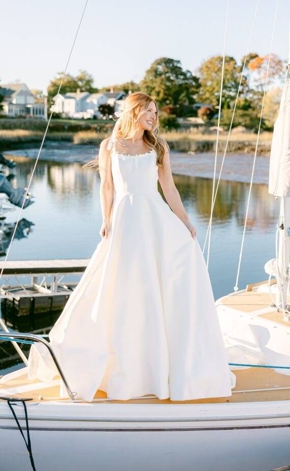 Model wearing a white dress on the boat