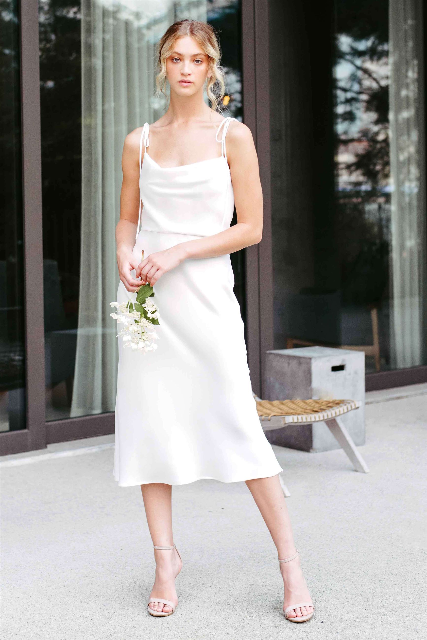 Bride wearing white slip dress with cowl neckline