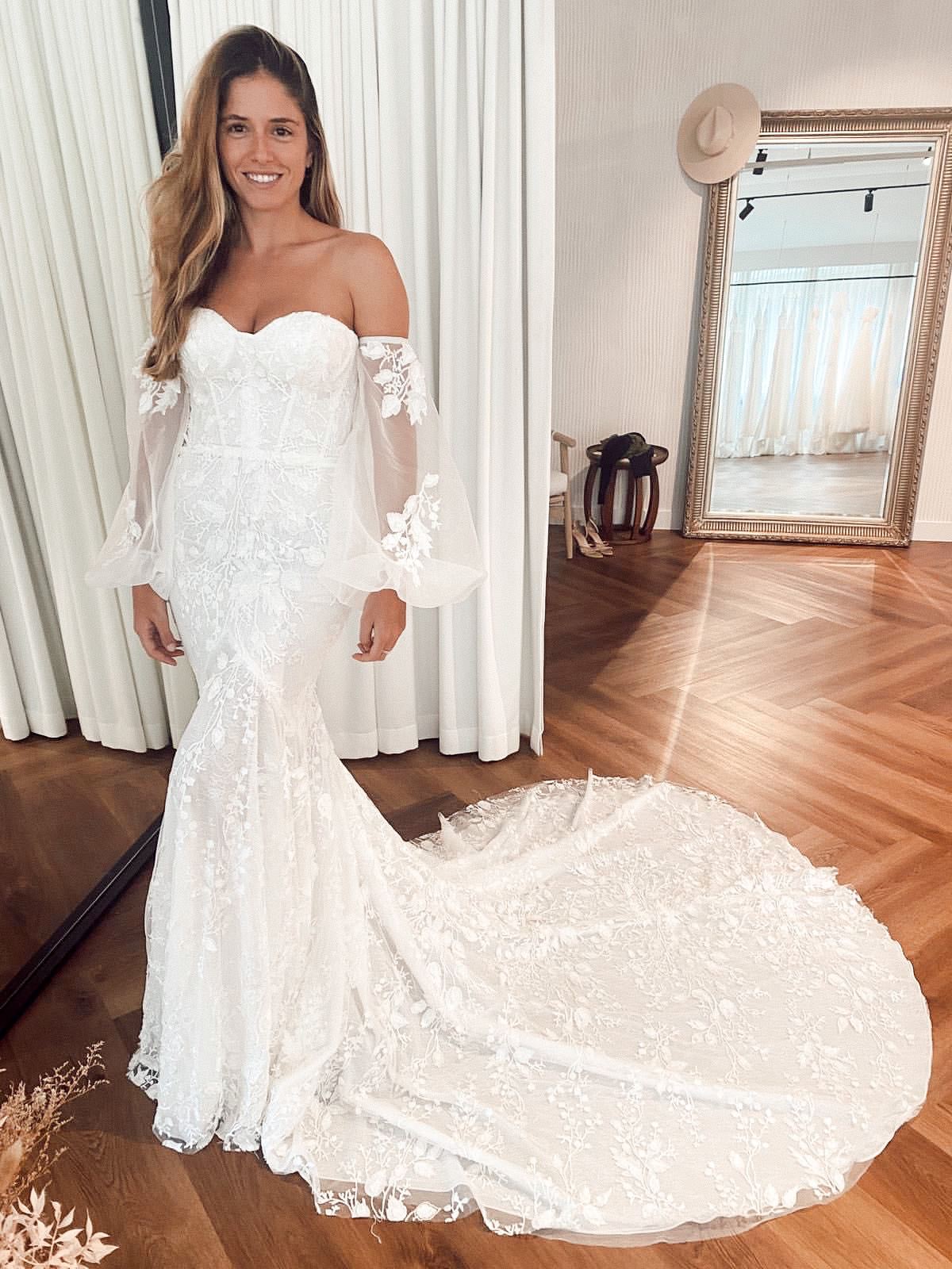 Bride wearing off the shoulder long sleeve wedding dress with balloon sleeves