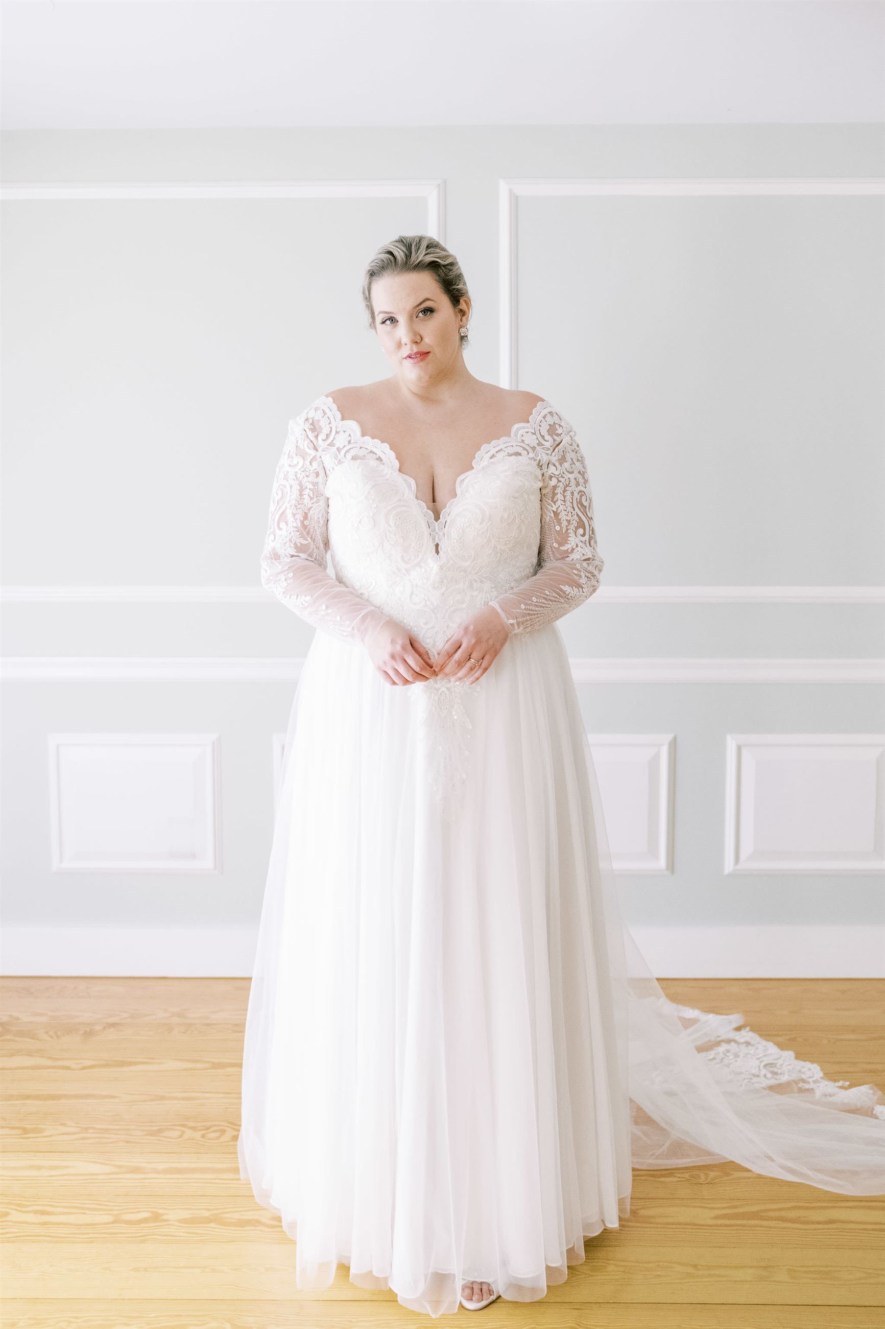 Plus size bride wearing lace long sleeve wedding dress